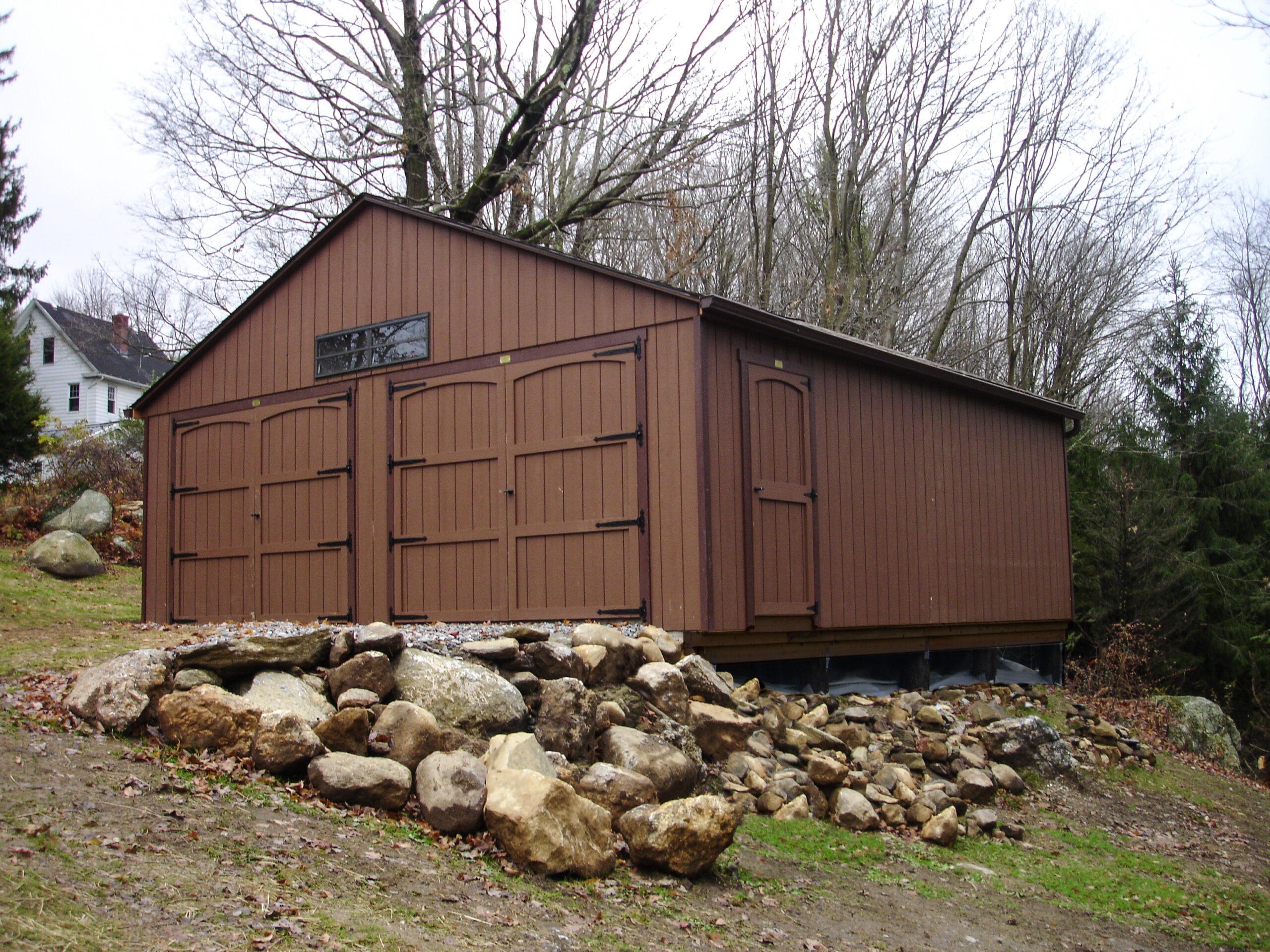 double door backyard garage on a hill