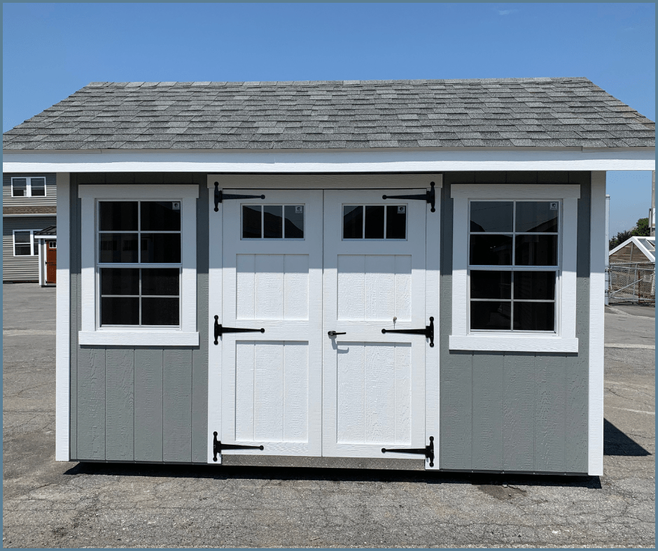 backyard shed nantucket style with double doors and roof overhang